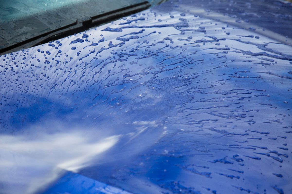 water being sprayed on car hood